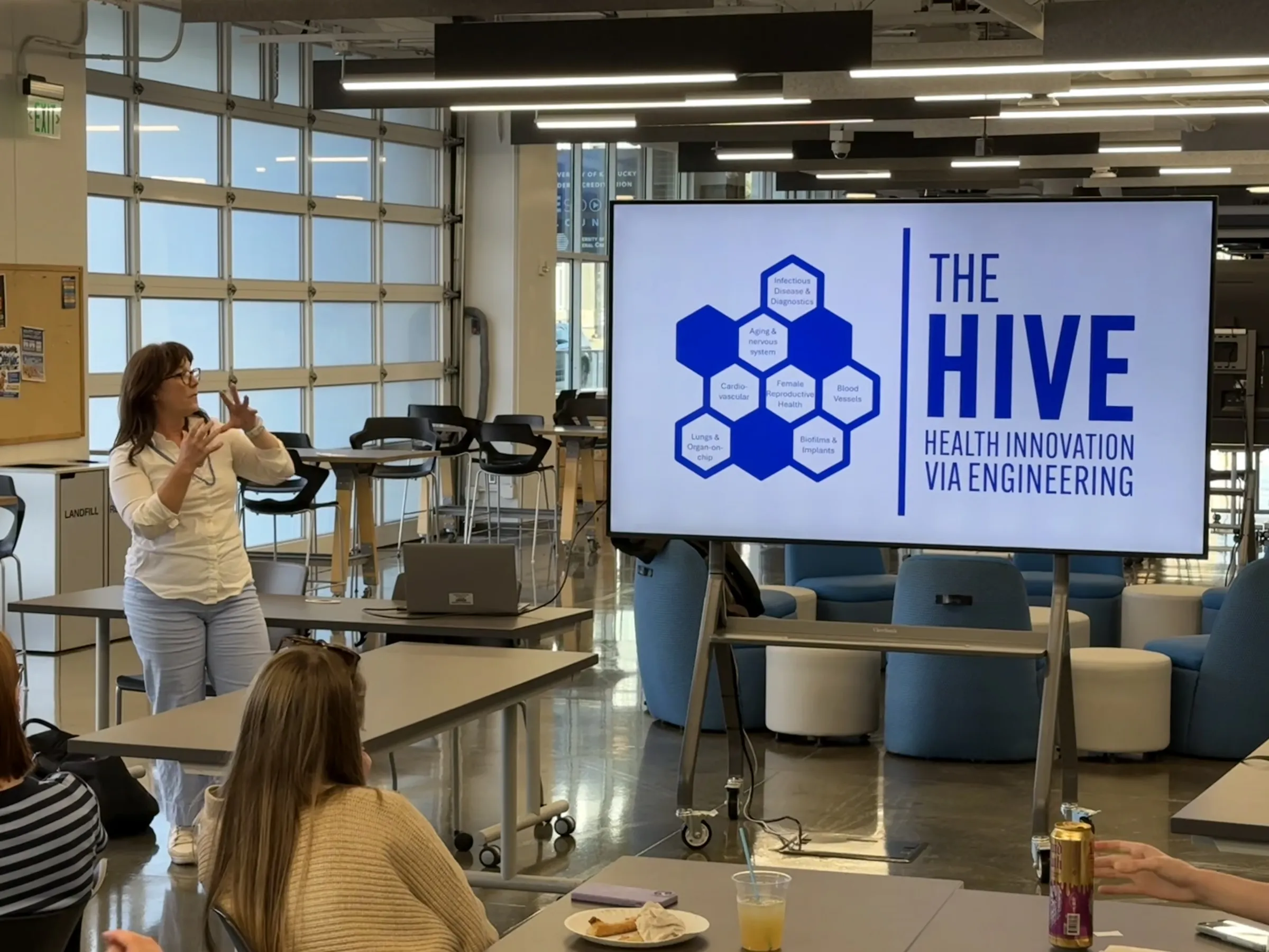 Dr. Martha Grady gives an overview of The HIVE. The HIVE core members are Scott Berry, Jon Zuidema, Jonathan Wenk, Samantha Zambuto, Brooks Lane, Christy Trinkle, and Martha Grady. The HIVE includes aerospace, mechanical, and biomedical engineering.