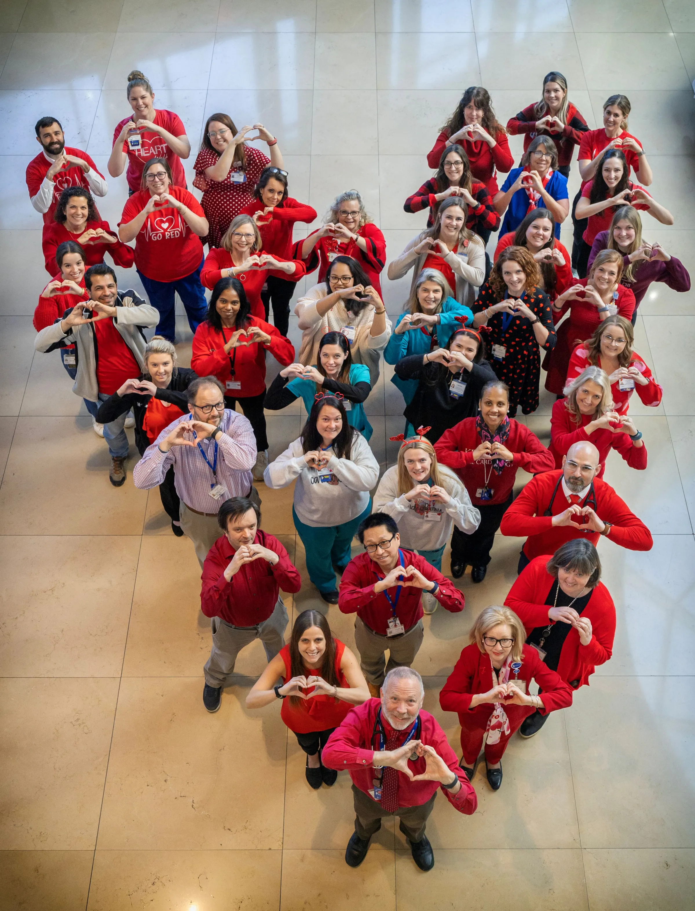 Cardiovascular Medicine team forms a heart while wearing red