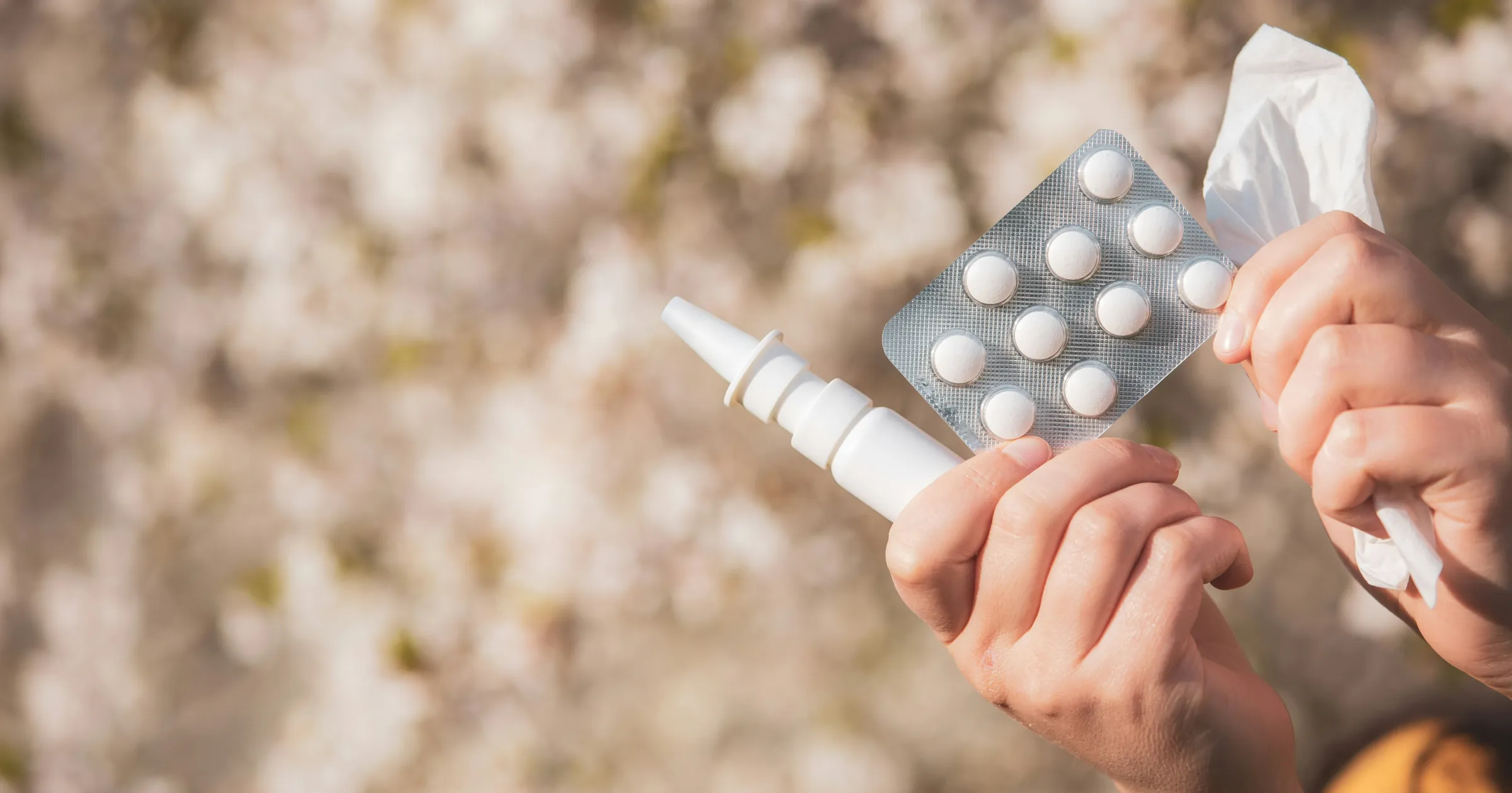 a woman holds pills and allergy pens