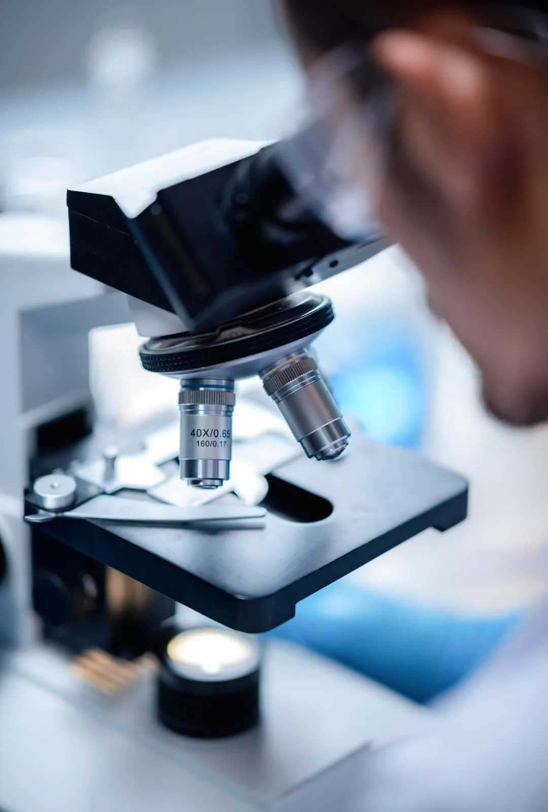Man looking through microscope