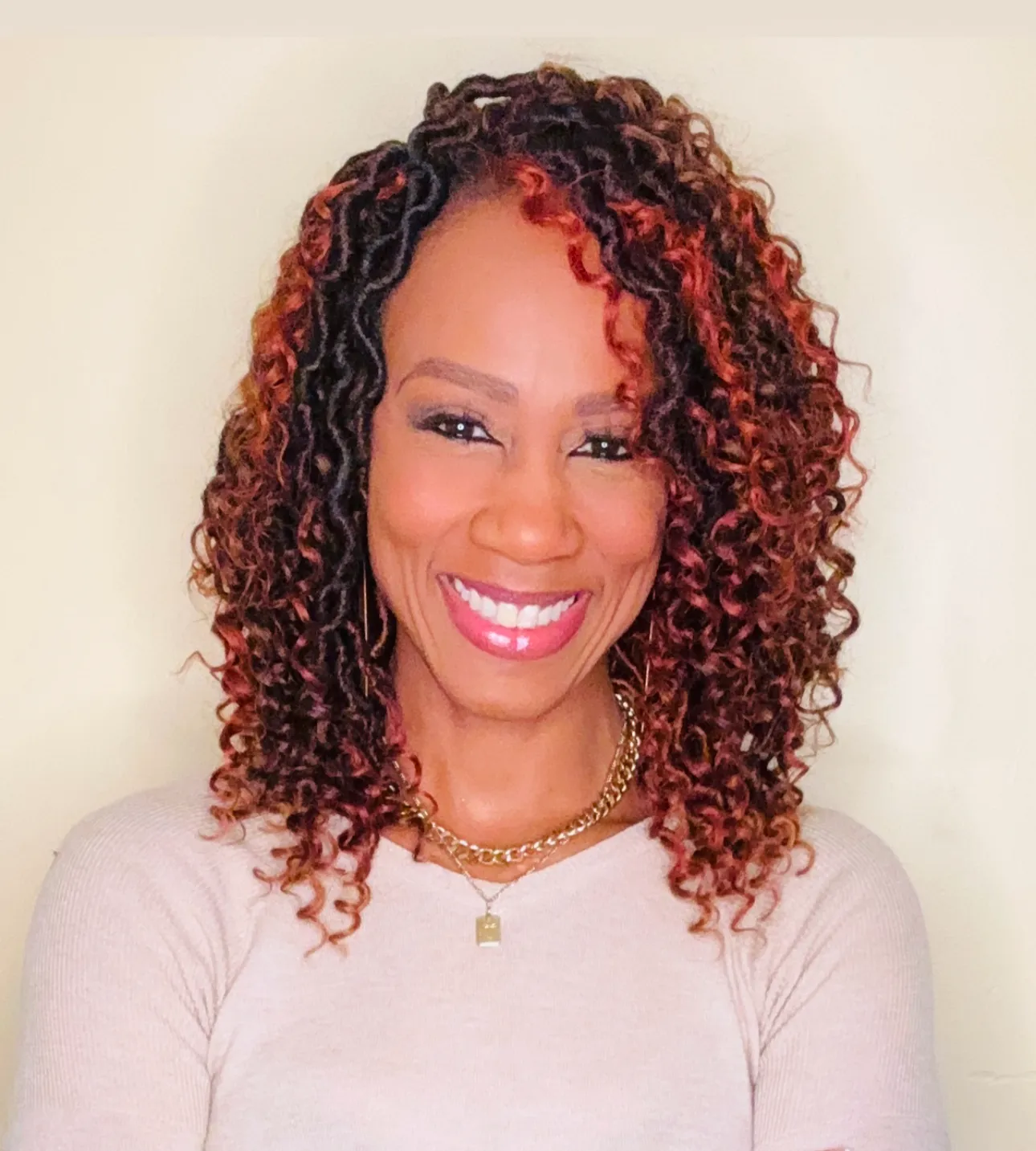 Image of Dr. Ketrell McWhorter a black women with shoulder length curly brown hair wearing a white top