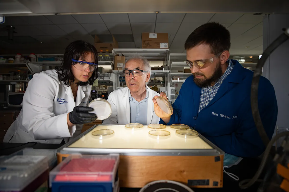 Dr. Steve Estus in laboratory with a female and a male scientist