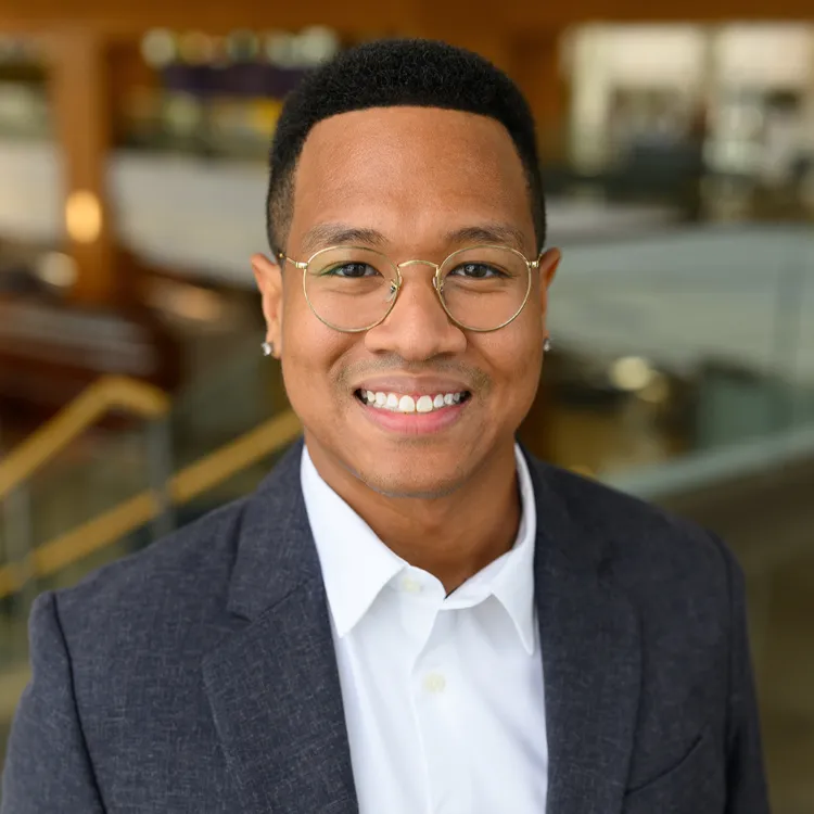 Dr. Delvon Mattingly, a man wearing glasses, a white shirt, and a dark blazer.