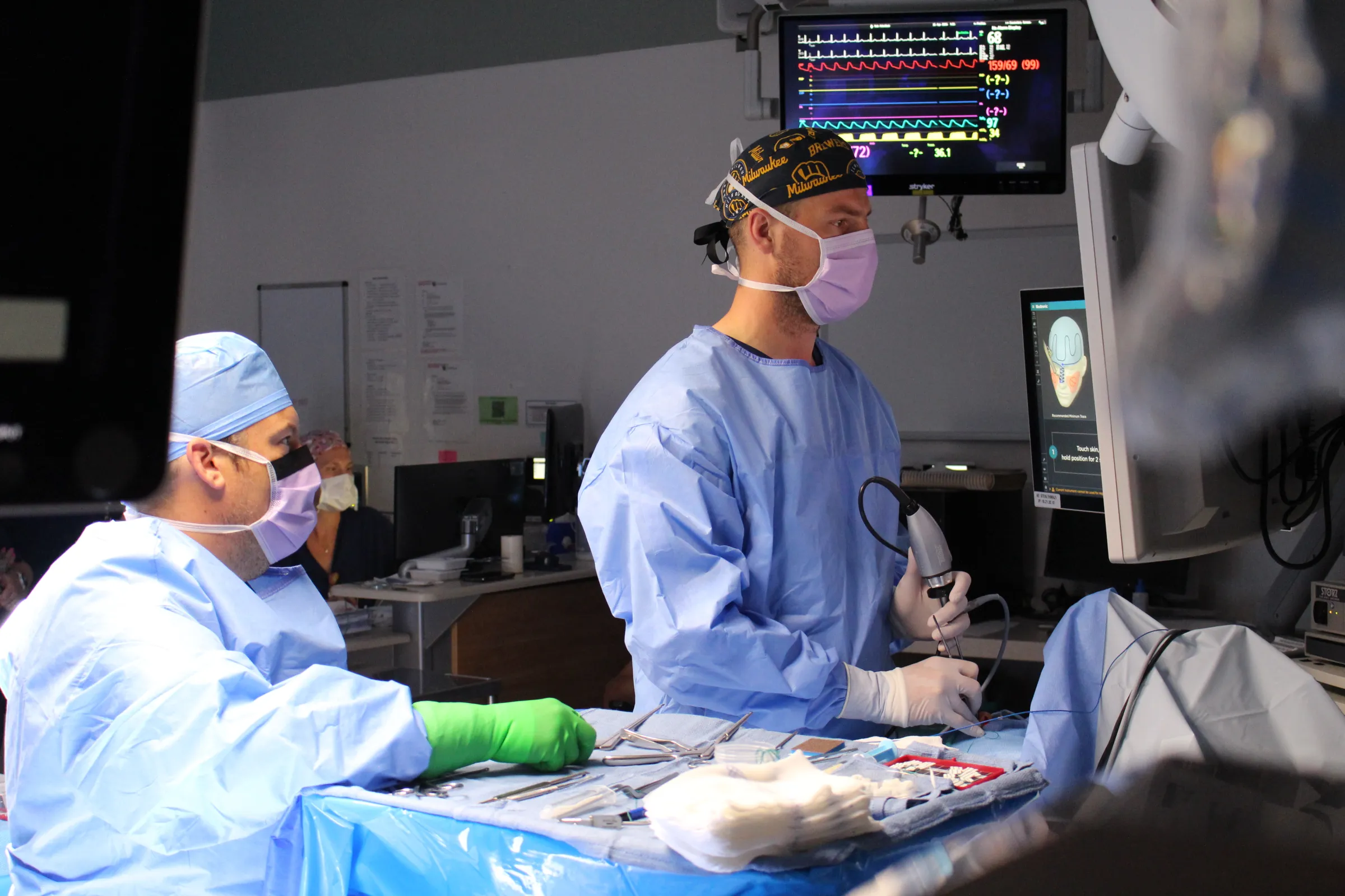 A picture of a otolaryngology resident performing surgery