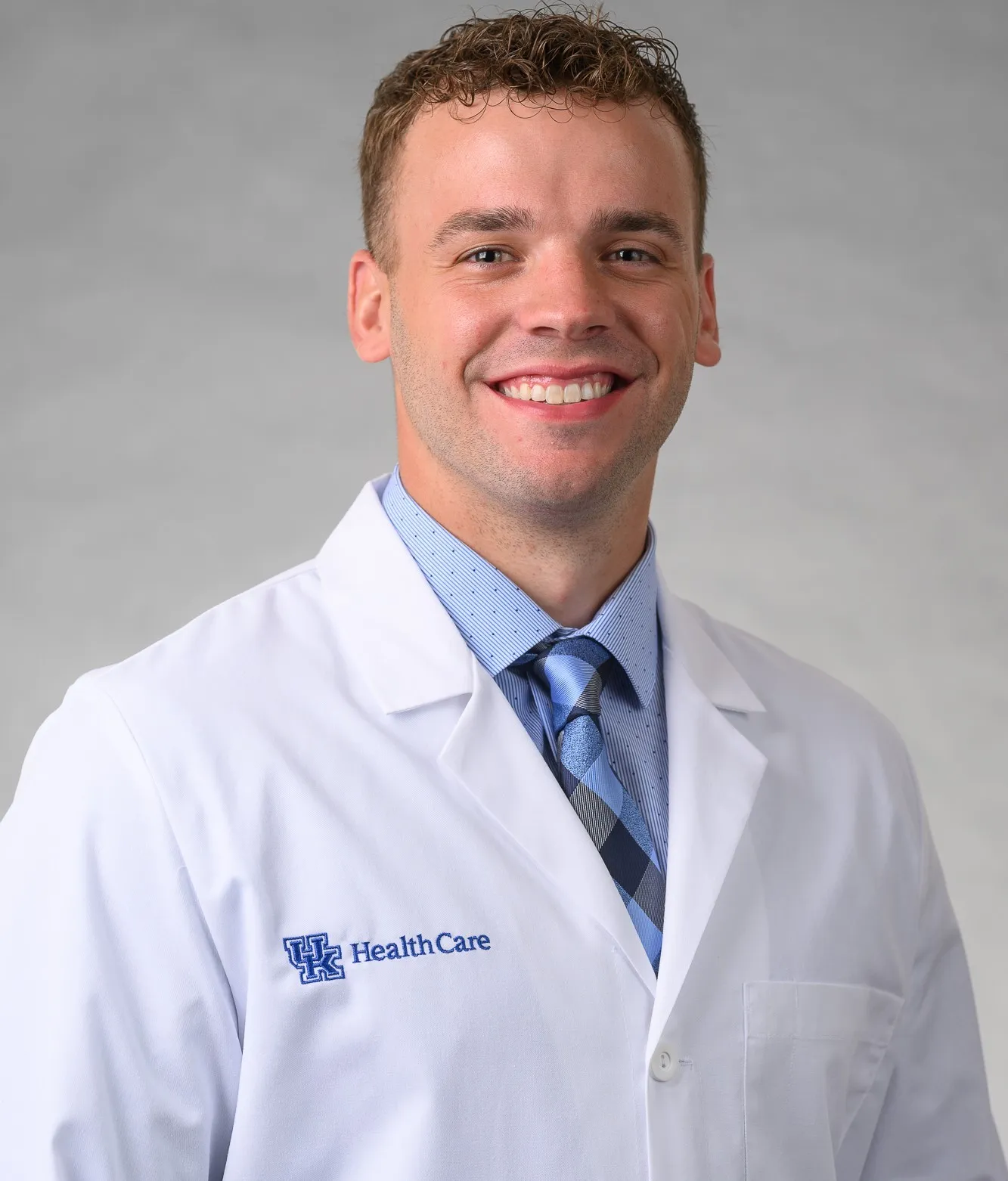 Ryan Harpole smiling in his white coat