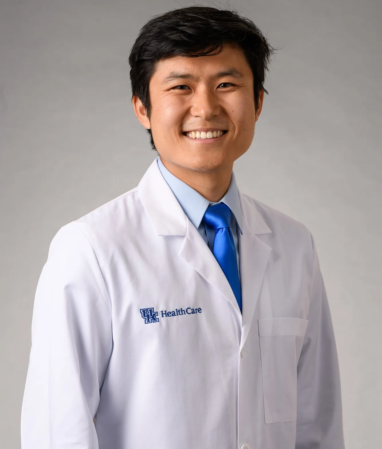 Kevin Wang smiling in his white coat