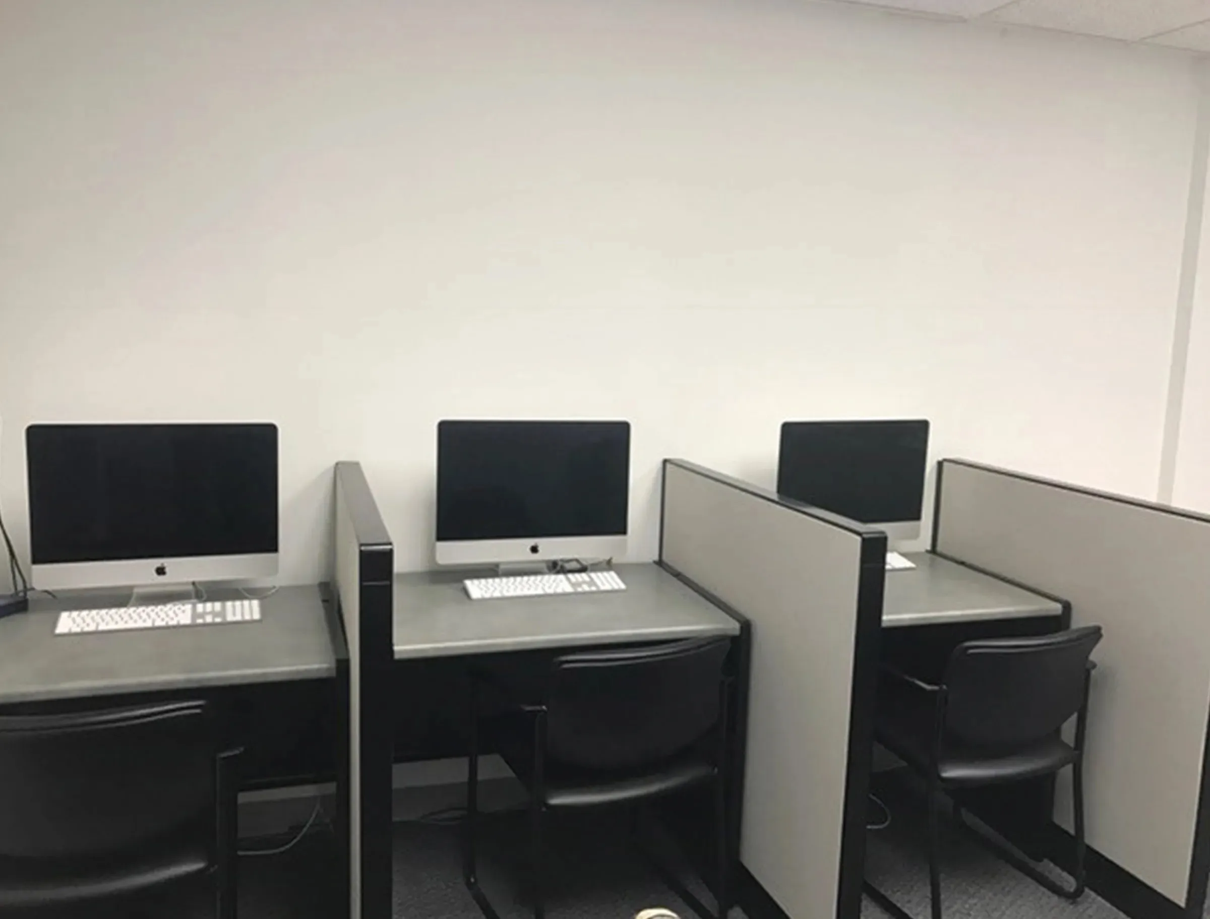Image of 3 desks with 3 computers