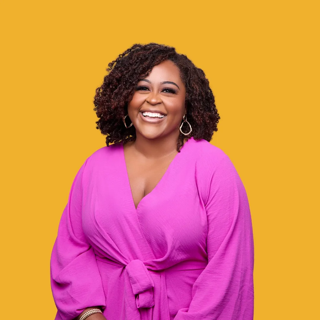 Image of Dr. Shemeka Thorpe, a black women smilling brightly with long curly hair wearing a pink dress on a yellow background