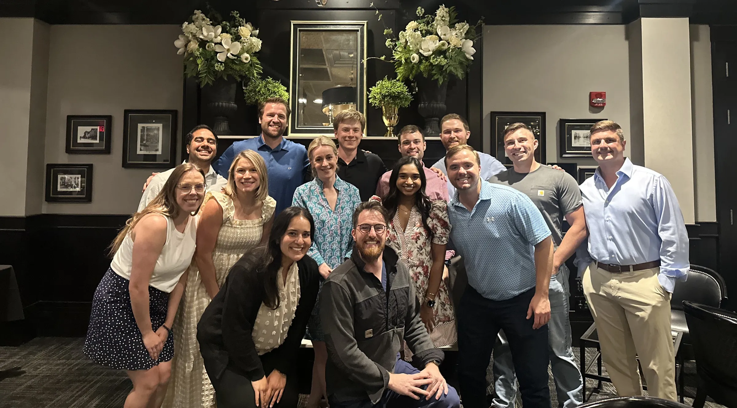 Residents pose for a photo together at a nice establishment