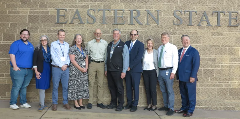 group standing outside entrance to eastern state hospital