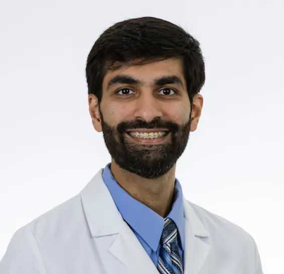 headshot of Dr. Bhatia in his white coat, smiling 