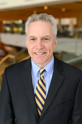 Doctor David Rodeberg in blue blazer and tie