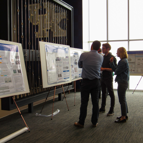 Students watching poster presentations