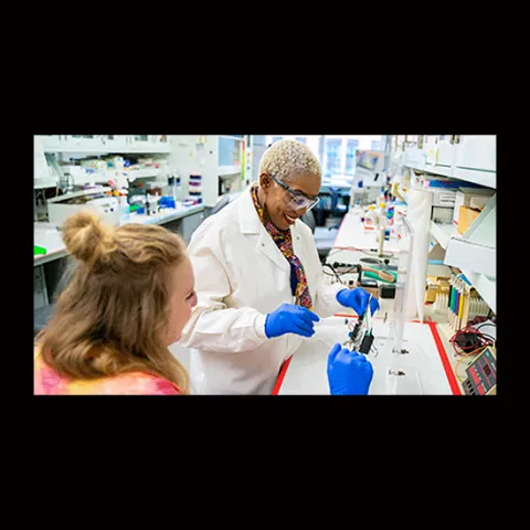 Dr. Yvonne Fondufe-Mittendorf in laboratory with unnamed person