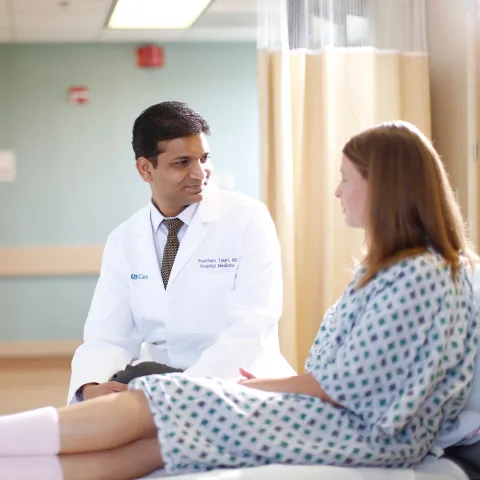 doctor and patient talking a patient bedside