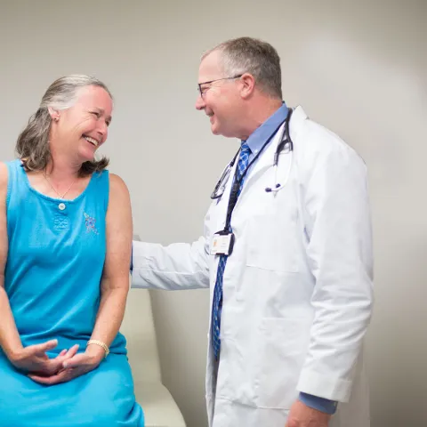 doctor speaking with patient on examination table