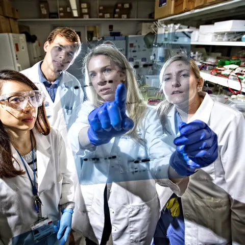 Professor in a lab with students