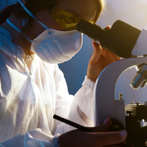 woman using microscope