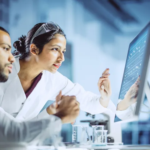 2 scientists looking at a computer screen