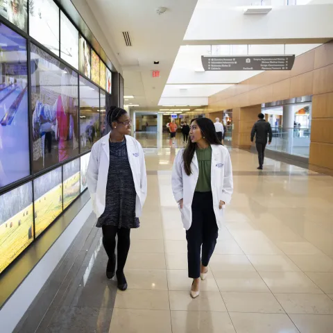 student and professor walking