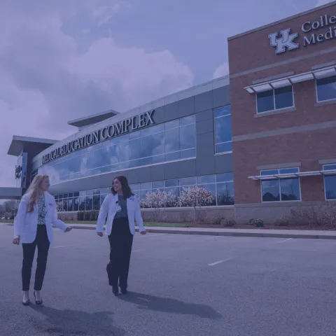 two medical students walking outside of the bowling green facility