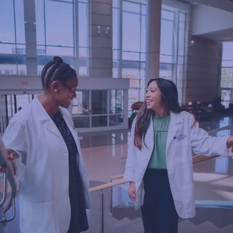 two medical students standing on the stairs at the UK hospital