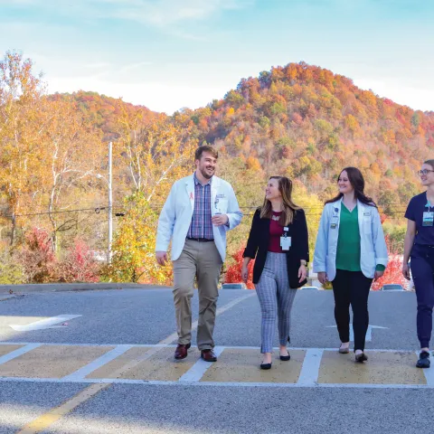 students walking on a street with mountains behind them