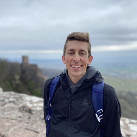 Brenden Garrett out on a hike, standing for a picture on the hillside.