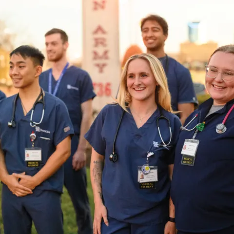 Salvation Army student-run clinic team smiling, standing outside.