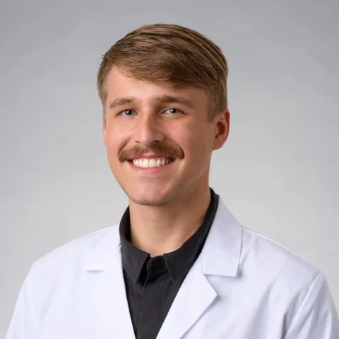 Clay huffman smiling in his white coat