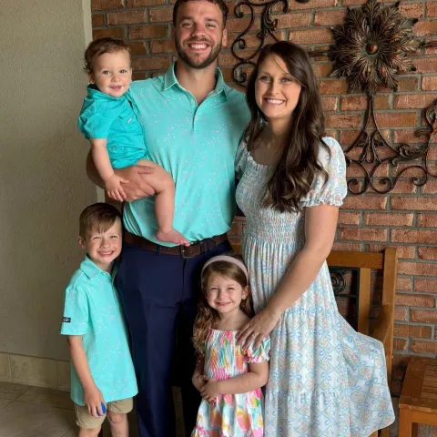 Ryan Harpole and his wife standing with his three kids. 