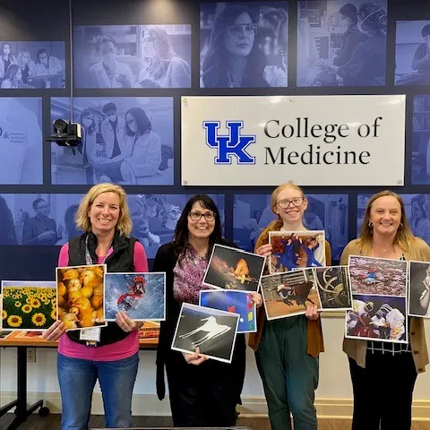 4 woman standing holding images