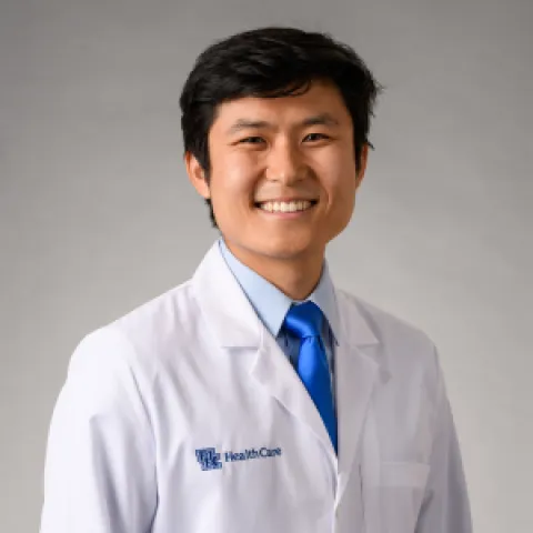 headshot of dr kevin wang in a UK white coat