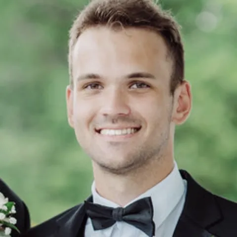 Male student standing in a tux