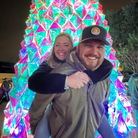 Image of man starting in front of christmas tree
