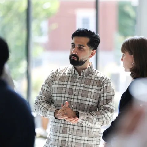 Scholar discussing their research at a poster session