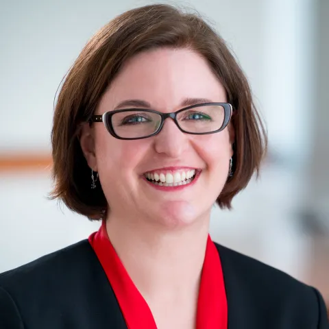 Lisa Wruck, Ph.D. A woman with short, brown hair and black-rimmed glasses.