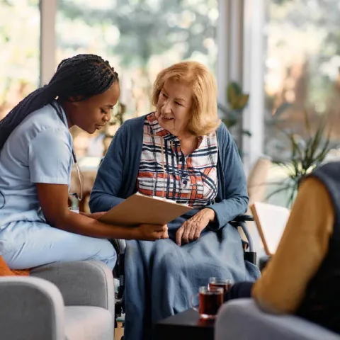 A nurse educating a caregiver on facility options. 