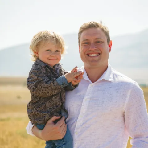 Profile shot of Jonathan Vincent, a TRIAD predoc trainee, with his young son.