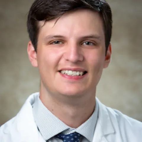 Headshot of Dr. Cody Blanchard smiling in his white coat