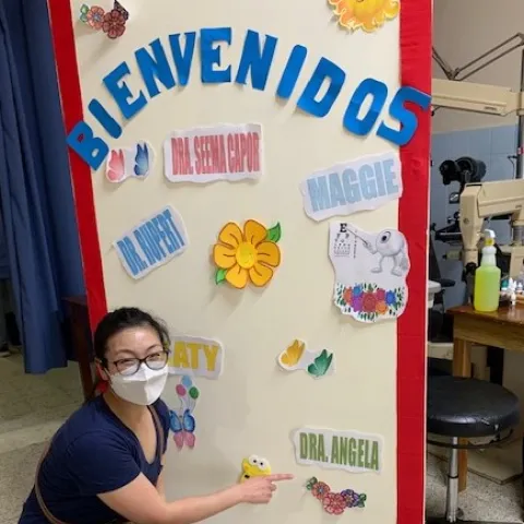 Angela Kim pointing at her name on a poster