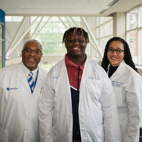 Dr. Darwin Conwell and Dr. Stephanie white pose with a student