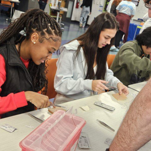 students practice suturing techniques at hs outreach event 
