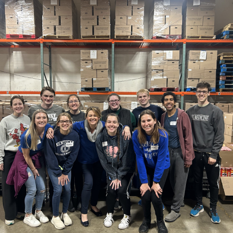 students and campus leadership pose as a group after volunteering at GoPantry