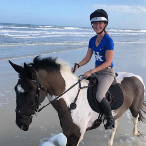 Kaitlyn Samuels riding a horse on the beach
