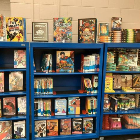 Three shelves of graphic design novels, nicknamed “Deon’s Corner” in Winburn Middle School’s library