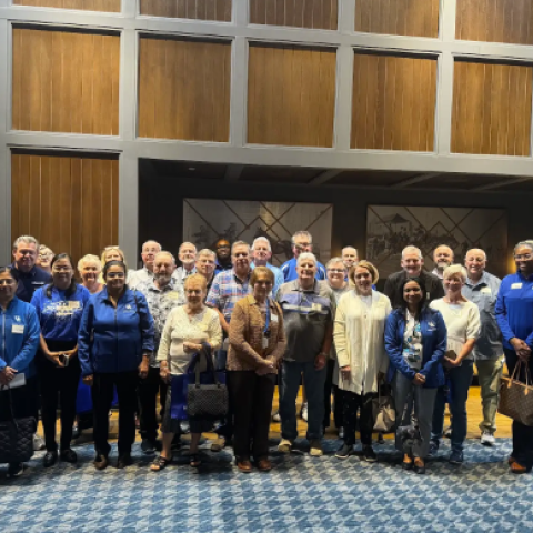 The group of speakers and attendees gathers for a photo.