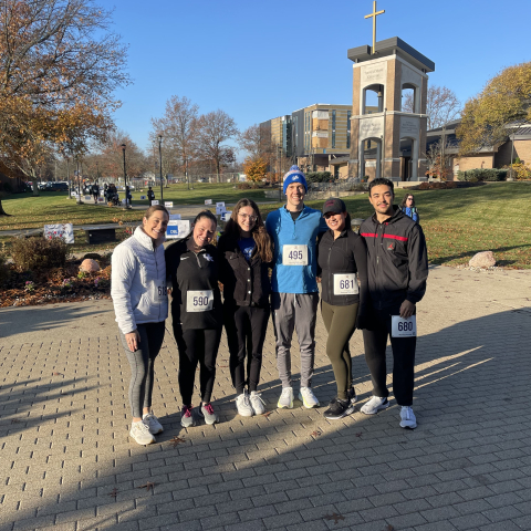 students pose together after participating in turkey trot 5K race 