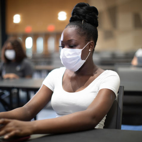 student in mask on computer in class.JPG