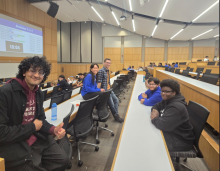 Medical student poses with group of undergraduate students during Medicats discussion